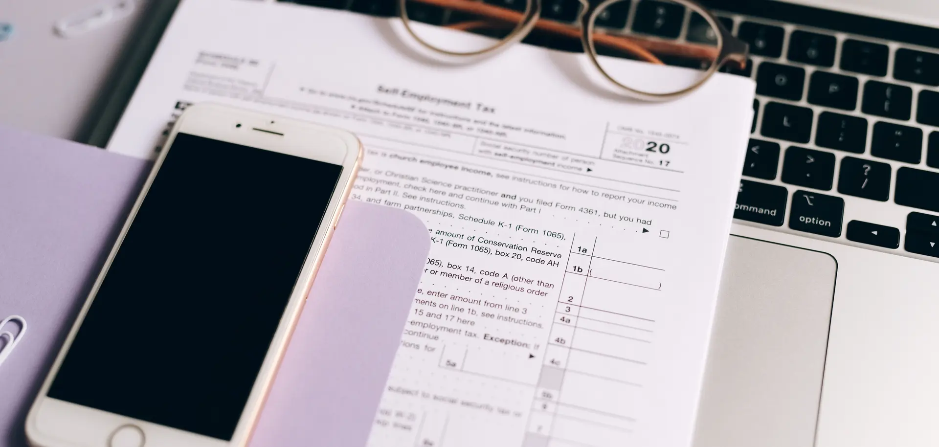 Laptop, calculator, and documents used to prepare tax returns