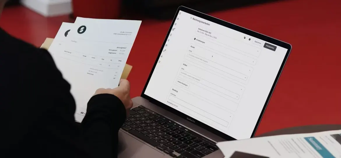 Tax professional reviewing documents and preparing information for online tax filing