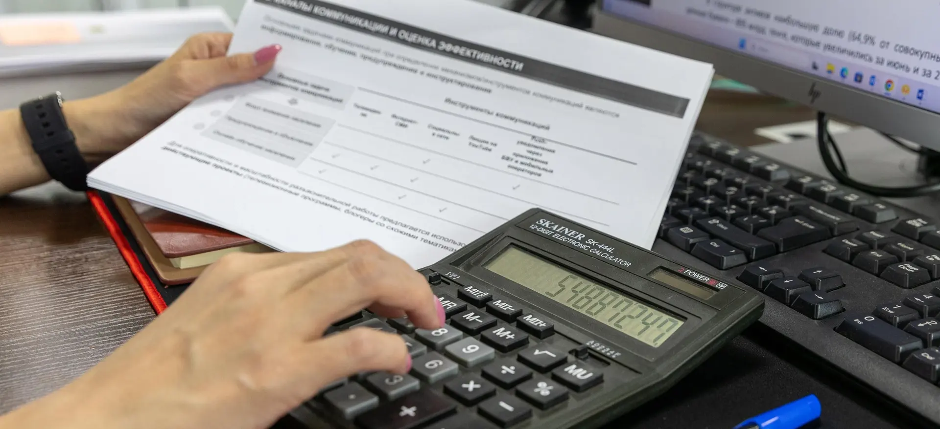 Accounting professional reviewing figures and reconciling monthly records