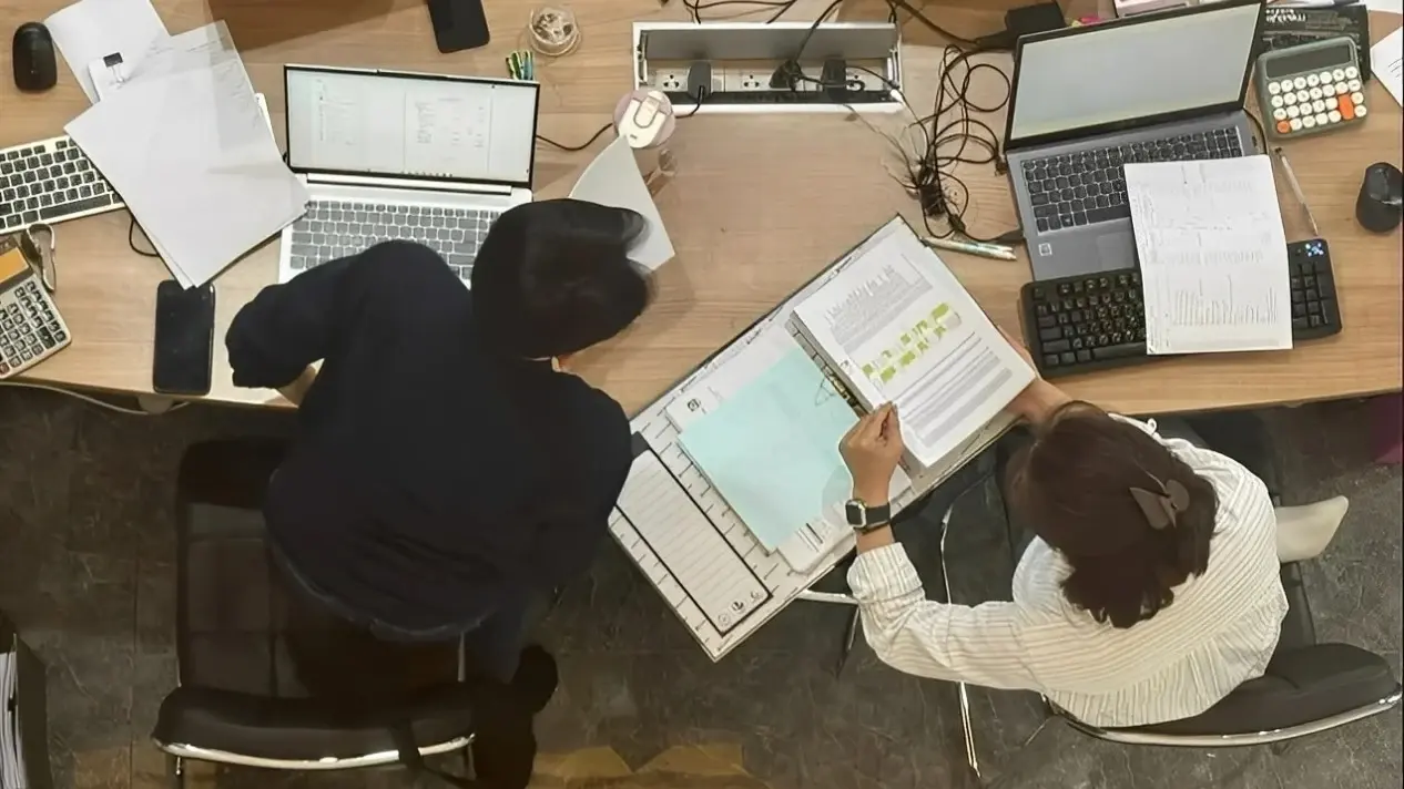 Accounting team reviewing outstanding documents during the liquidation of a Thai company
